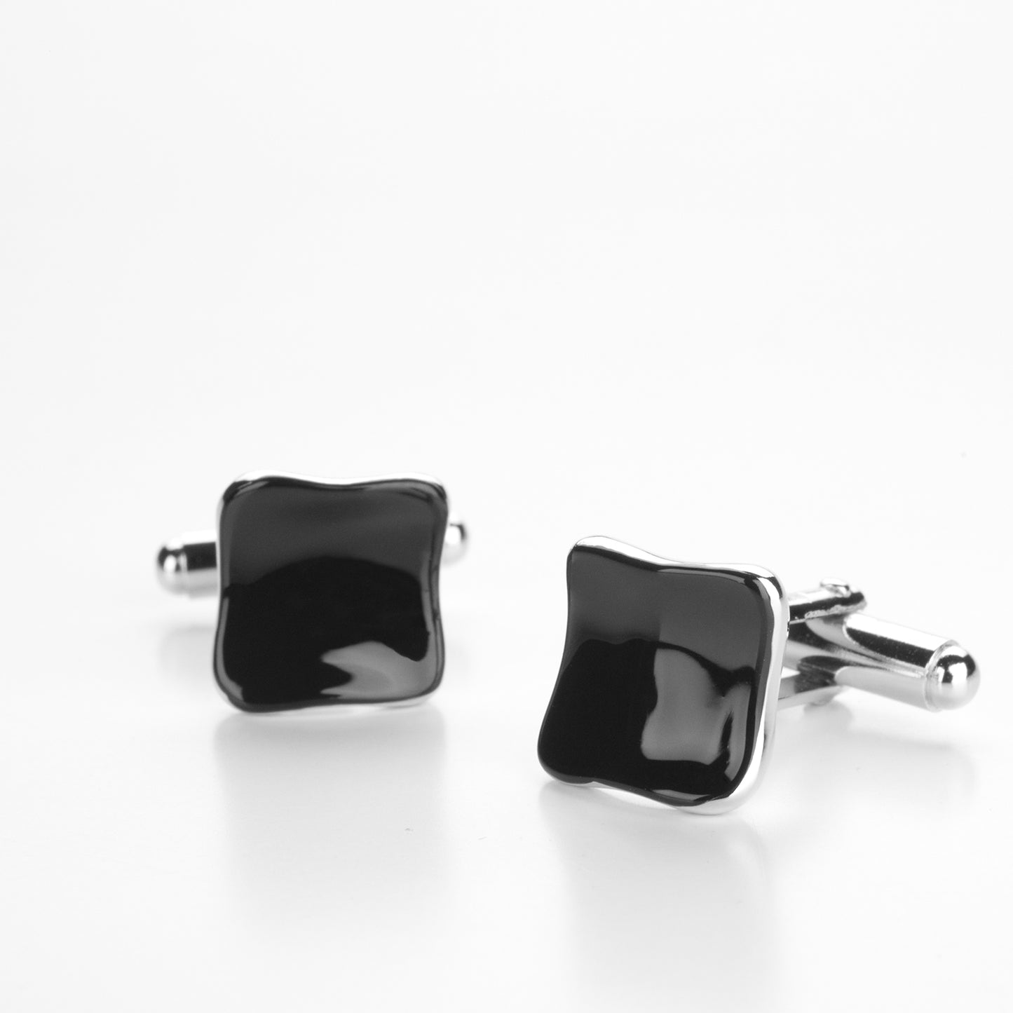 Square cufflinks in silver and black enamel.