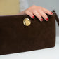 Clutch bag in brown leather with enameled silver detail