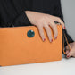 Clutch bag in orange leather with enameled silver detail