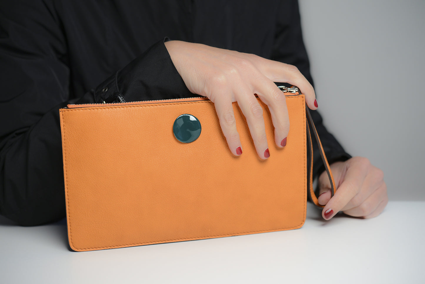 Clutch bag in orange leather with enameled silver detail