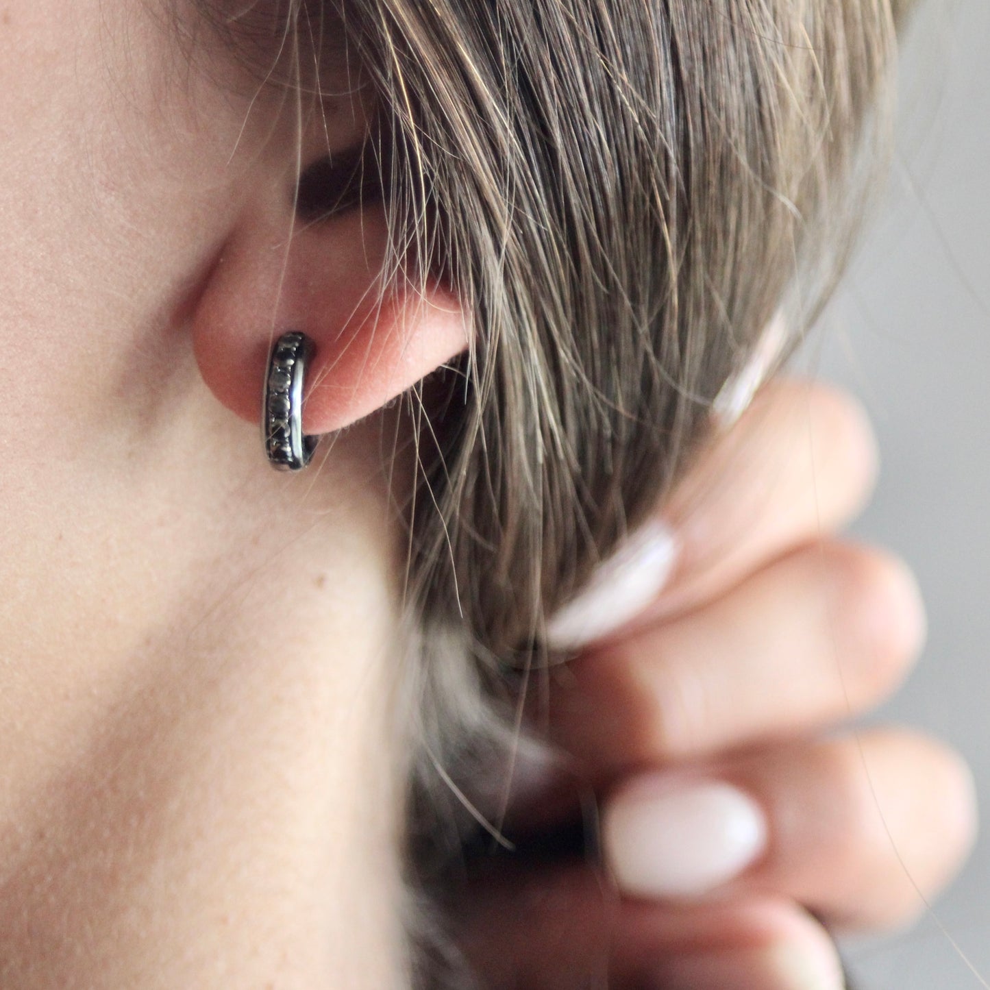 Bold huggie hoop earrings with black diamonds